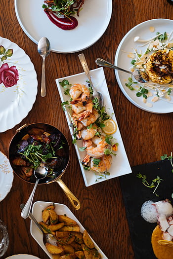 An overhead view of a beautifully arranged dining table featuring various gourmet dishes, perfect for a culinary experience. HD phone wallpaper