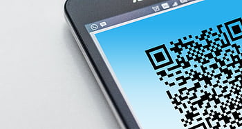 High-resolution close-up of a smart displaying a QR code on its screen. HD wallpaper