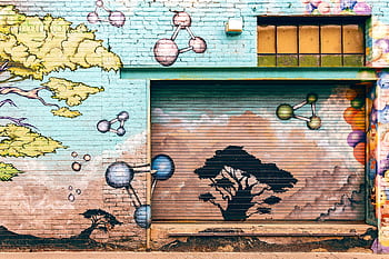 Colorful mural on a brick wall in Pasadena featuring trees and molecular shapes. HD wallpaper