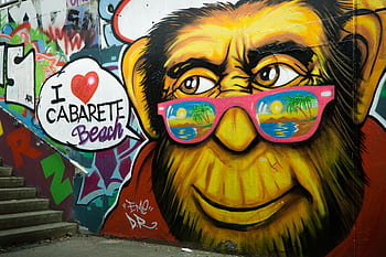 Colorful street art of a monkey with sunglasses on stairs, featuring Cabarete Beach text. HD wallpaper