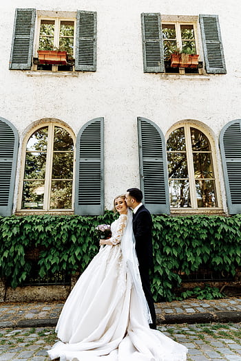Elegant bride and groom share a joyful moment outside a charming Parisian building. HD phone wallpaper