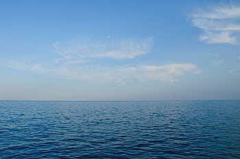 Calm ocean view with clear blue sky, perfect for backgrounds or . HD wallpaper