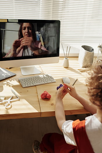 A child engaging in an online arts and crafts class, learning from home with clay and a computer. HD phone wallpaper