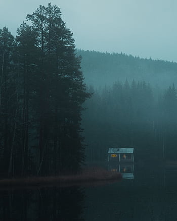 Serene misty morning scene with a secluded cabin by a tranquil lake in Västernorrland, Sweden. HD phone wallpaper