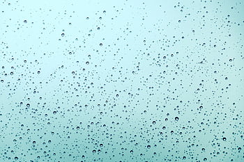A serene abstract view of water droplets scattered across a smooth glass surface, expressing tranquility. HD wallpaper