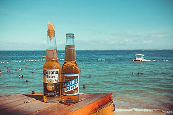 Two cold beers on a table overlooking a tropical beach in Lapu-Lapu City, Philippines. HD wallpaper