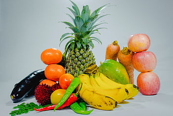 A colorful display of fresh tropical fruits and vegetables for healthy eating. HD wallpaper