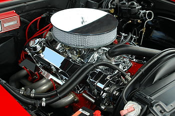 Detailed view of a polished, high-performance car engine showcasing chrome detailing and intricate mechanics. HD wallpaper