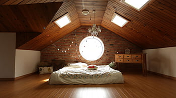 A warm and inviting attic bedroom featuring a unique brick wall and wooden ceiling design. HD wallpaper