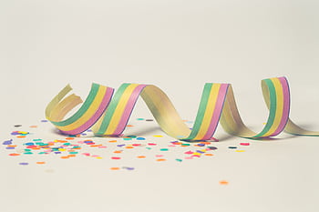 Bright pastel paper streamer with scattered confetti, perfect for celebration themes. HD wallpaper