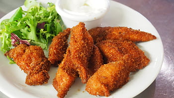 Delicious crispy fried chicken tenders served with a fresh green salad and dipping sauce. HD wallpaper