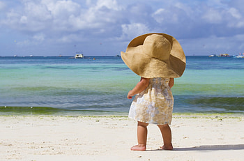 Sweet Beach Baby, sweet, sand, darling, girl, beach, boats, sun dress, clouds, sky, adorable, child, hat, ocean HD wallpaper