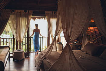 Peaceful bedroom in tropical villa with balcony view, perfect for relaxation. HD wallpaper