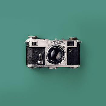 Classic vintage camera with a green background, symbolizing retro graphy and nostalgia. HD phone wallpaper