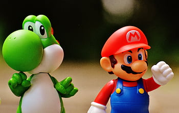 Detailed close-up of Mario and Yoshi figurines from a popular video game franchise. HD wallpaper