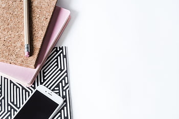 Stylish flat lay of a creative workspace with notebook, pencil, and smart on a white background. HD wallpaper