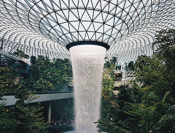 Stunning view of the indoor waterfall at Jewel Changi Airport, Singapore's architectural marvel. HD wallpaper