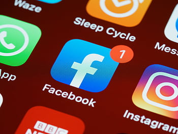 A detailed close-up of social media app icons on a smart screen. HD wallpaper
