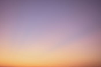A serene gradient sky with hues of blue, pink, and orange during twilight. HD wallpaper