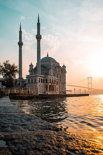 Ortaköy Mosque by the Bosphorus at sunset, capturing the harmony of architecture and landscape in Istanbul. HD phone wallpaper