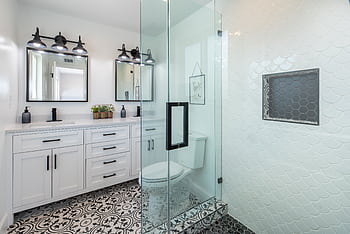 Elegant white bathroom with glass shower and stylish patterned floor. HD wallpaper