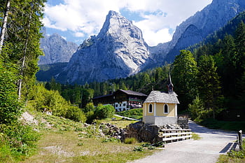 Idyllic view of a chapel and mountains in Kufstein, Tirol, Austria under a bright sky. HD wallpaper