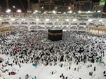Crowds gather around the Kaaba during the Hajj pilgr, Al-Masjid Al-Haram, Mecca, at night. HD wallpaper