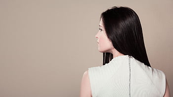 Profile view of a brunette woman in white attire indoors on a neutral background. HD wallpaper