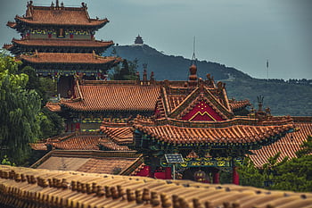 Explore the stunning ancient architecture of a Chinese pagoda in Shanxi, featuring intricate roofs and lush surroundings. HD wallpaper