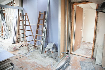 Construction site featuring ladders and tools in a home renovation setting. HD wallpaper