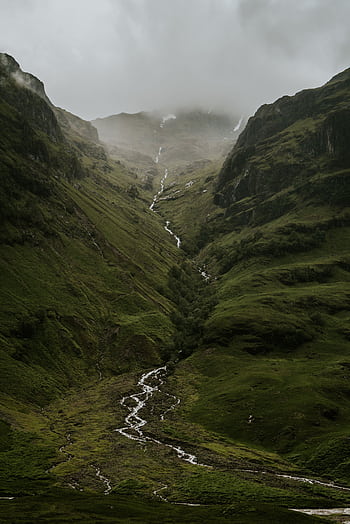 A breathtaking view of a misty highland valley in Scotland with a flowing river. HD phone wallpaper