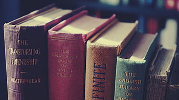 Aesthetic collection of vintage books showcasing classic literature with textured covers. HD wallpaper