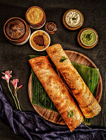 Delicious traditional dosa served with a variety of Indian chutneys and sambar on banana leaves. HD phone wallpaper