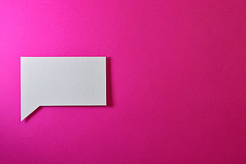 A minimalistic white paper speech bubble on a vibrant pink background, perfect for design projects. HD wallpaper