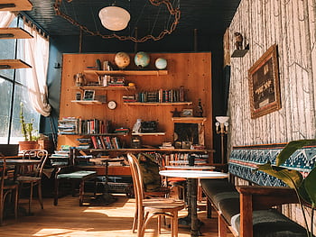 A charming cafe setting in Silver Plume featuring books, globes, and vintage decor. Ideal for cozy reading sessions. HD wallpaper