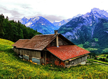 Mountain house, peaks, peaceful, rustic, serenity, wildflowers, rural, greenery, snowy, house, clope, beautiful, grass, mountain, cliffs, valley, nature, sky, mountainscape, lovely, village HD wallpaper