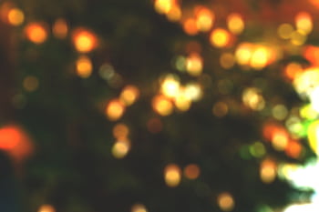 Blurred festive bokeh lights creating a warm and cozy holiday atmosphere. HD wallpaper