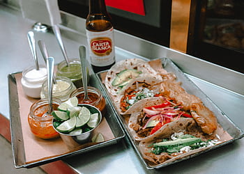Delicious Mexican tacos served with sauces and lime, paired with Carta Blanca beer in Mexico City. HD wallpaper