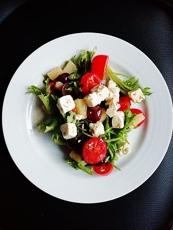 Delicious Greek salad featuring fresh vegetables and creamy feta cheese, perfect for a healthy meal. HD phone wallpaper