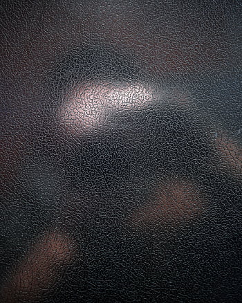 Close-up of a textured black leather surface with a distinct cracked pattern, perfect for backgrounds. HD phone wallpaper