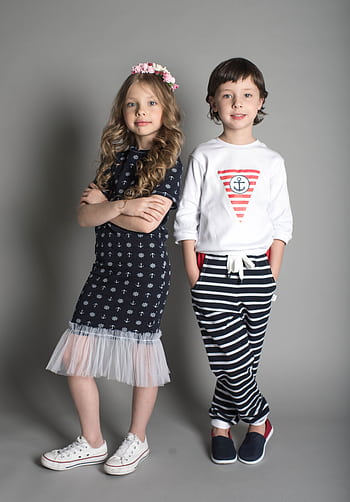 Two children posing in stylish nautical-themed outfits. HD phone wallpaper
