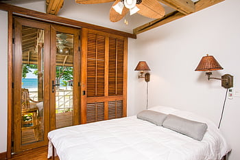 A serene beachfront bedroom with modern design and ocean view. HD wallpaper