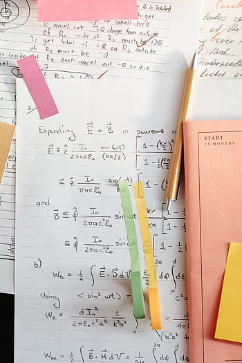 Detailed math notes with handwritten equations and colorful papers, perfect for educational use. HD phone wallpaper