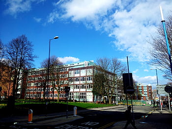 A modern building with clear blue skies in an urban setting, perfect for business and cityscape themes. HD wallpaper