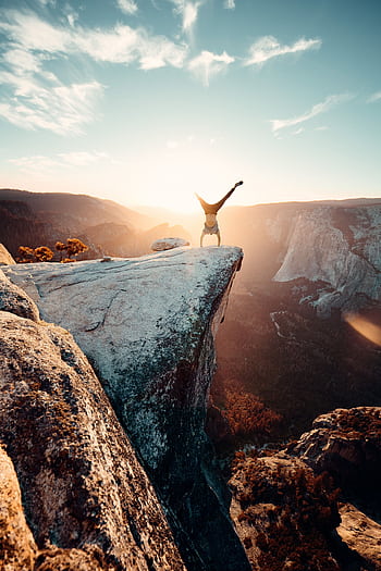 Thrilling handstand on a cliff edge in Yosemite National Park during sunset. HD phone wallpaper