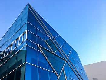 Striking blue glass building against a clear sky in Hải Châu, Vietnam. HD wallpaper
