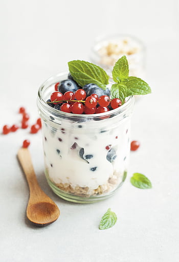 A delicious yogurt parfait with fresh berries and mint leaves, perfect for a healthy breakfast. HD phone wallpaper