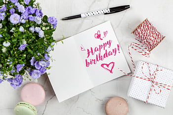 Charming birtay greeting card layout with macarons, flowers, and gift box. HD wallpaper
