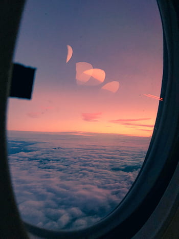 Gorgeous aerial view from an airplane window at sunset, highlighting the colorful sky and clouds. HD phone wallpaper