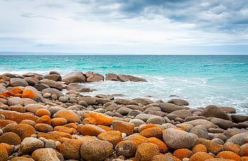 A tranquil, rocky coastline in South Australia with vibrant ocean views. HD wallpaper